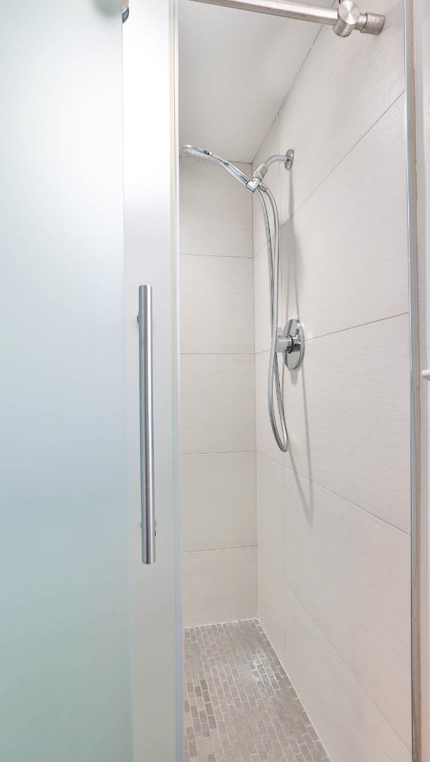 22344 McClellan Road Cupertino, CA 95014 - Photo 36 of 42 a bathroom with a glass shower door