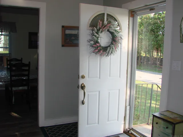 a living room with furniture wooden floor and a large window
