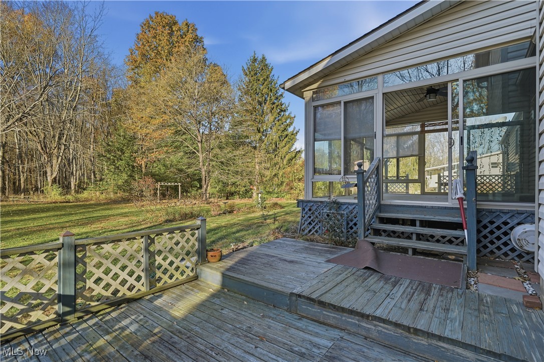 3275 Ranfield Road Kent, OH 44240 - Photo 8 of 33 Wooden terrace featuring a sunroom and a yard