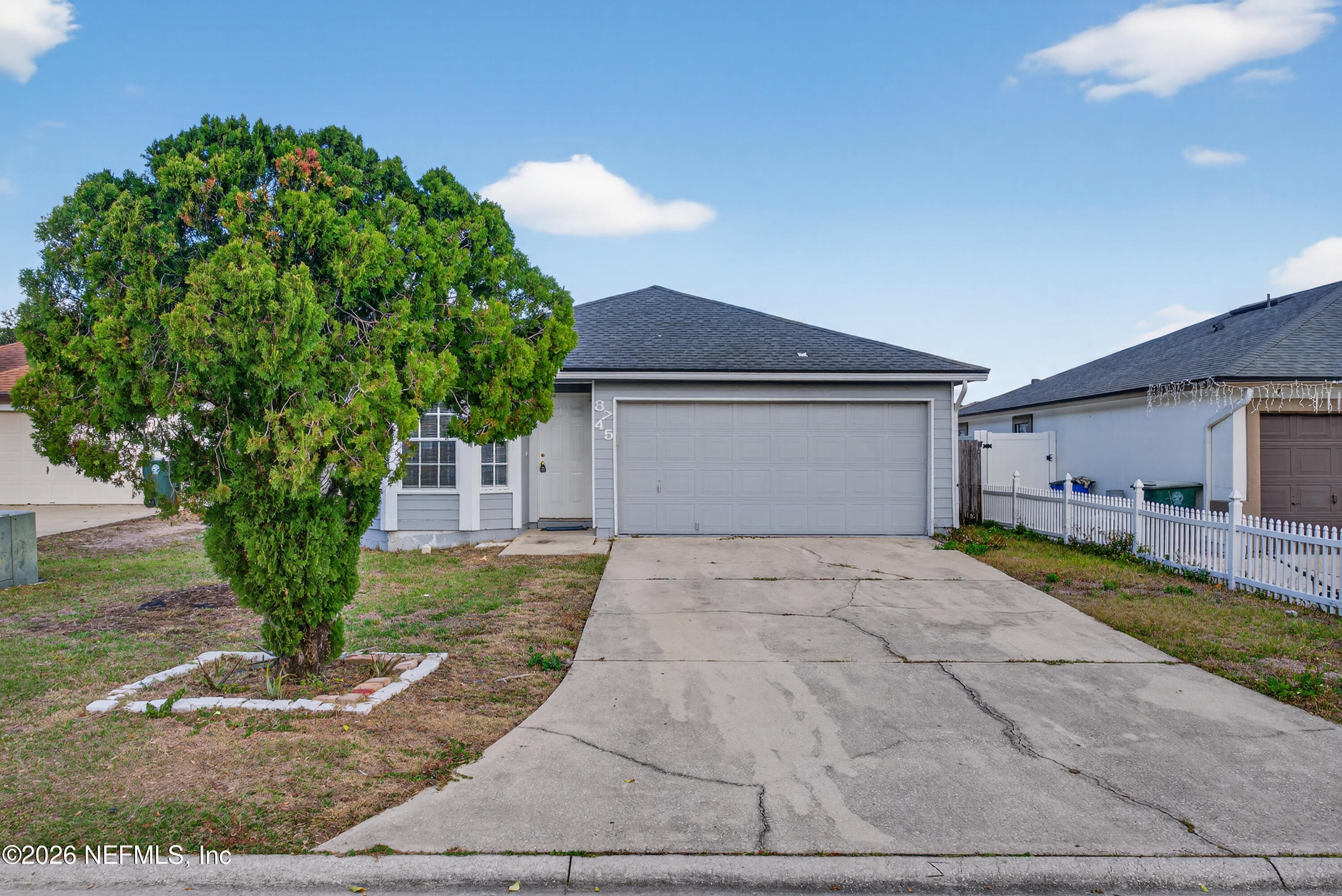 8745 Buzz Court Jacksonville, FL 32216 - Photo 1 of 23 a front view of a house with garden