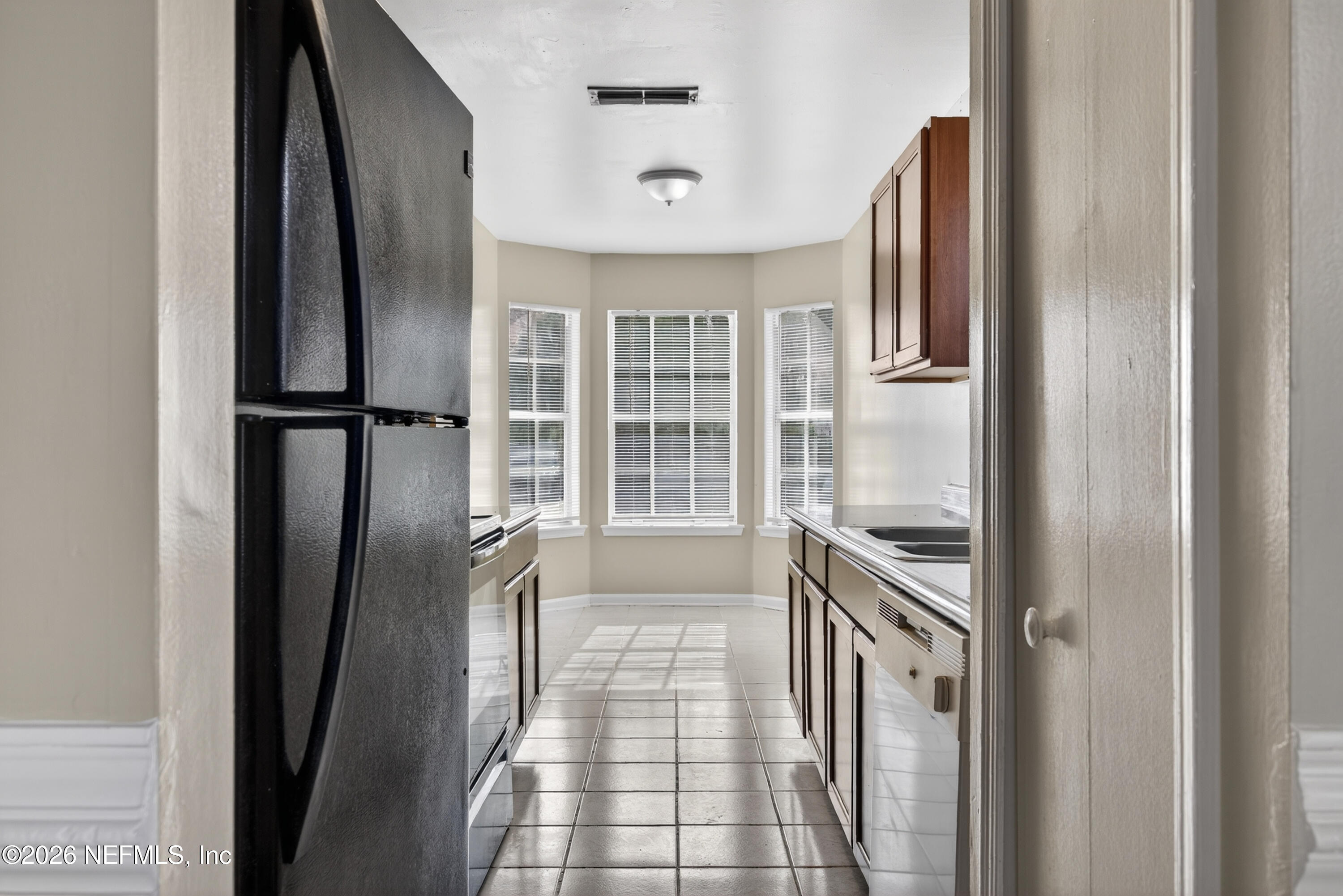 8745 Buzz Court Jacksonville, FL 32216 - Photo 11 of 23 a view of a kitchen from the hallway