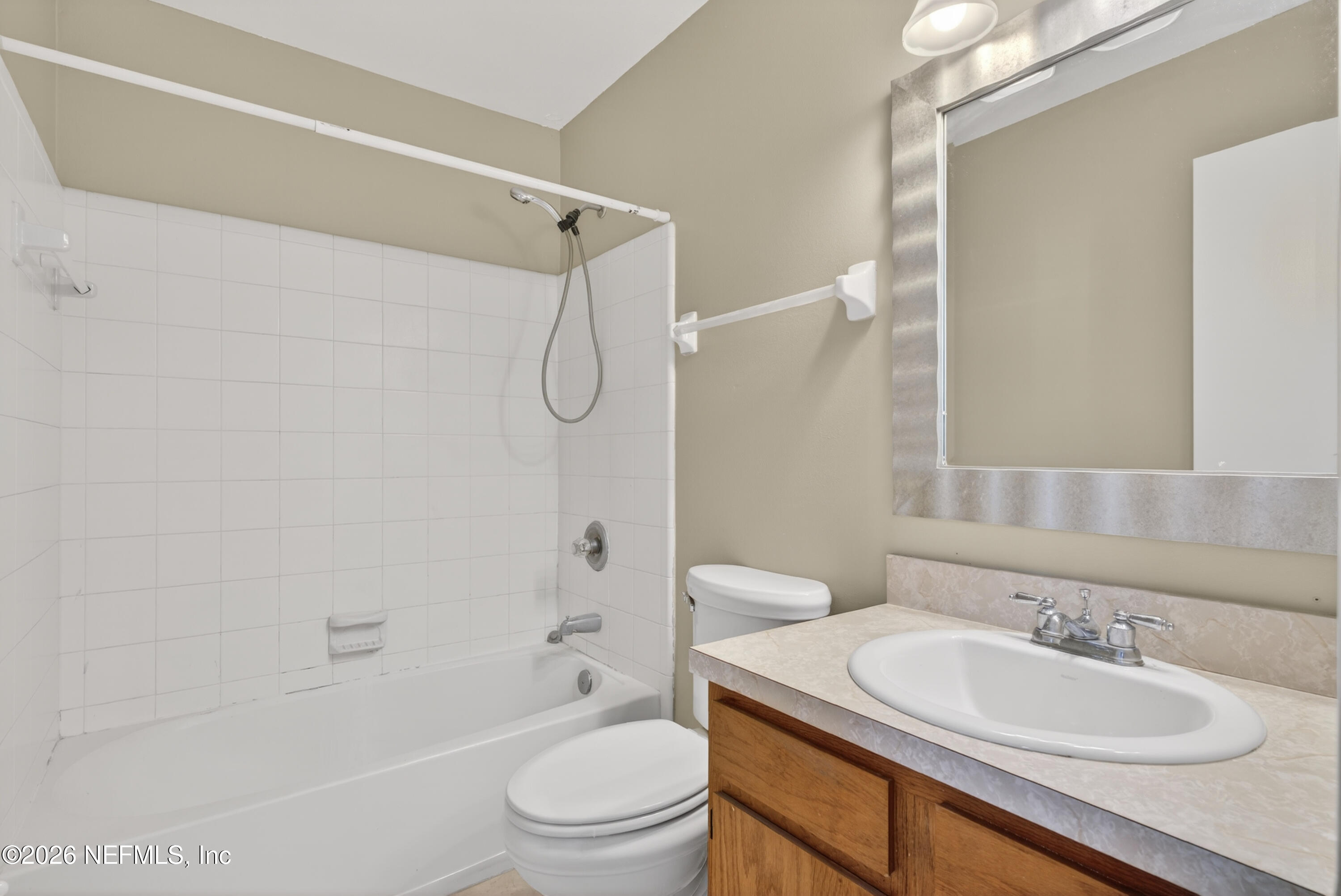 8745 Buzz Court Jacksonville, FL 32216 - Photo 14 of 23 a bathroom with a granite countertop sink toilet mirror and shower