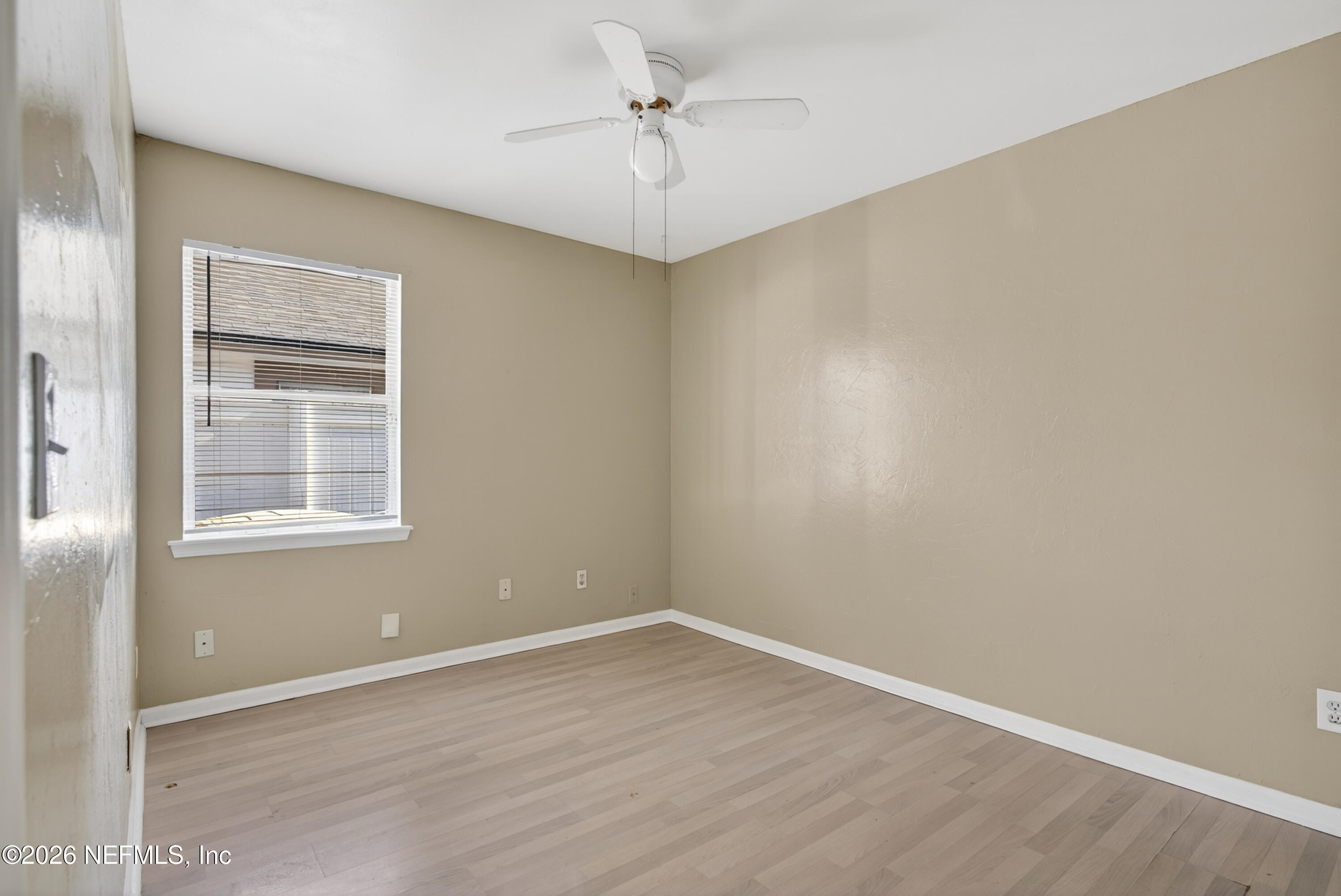 8745 Buzz Court Jacksonville, FL 32216 - Photo 15 of 23 an empty room with a window and a ceiling fan