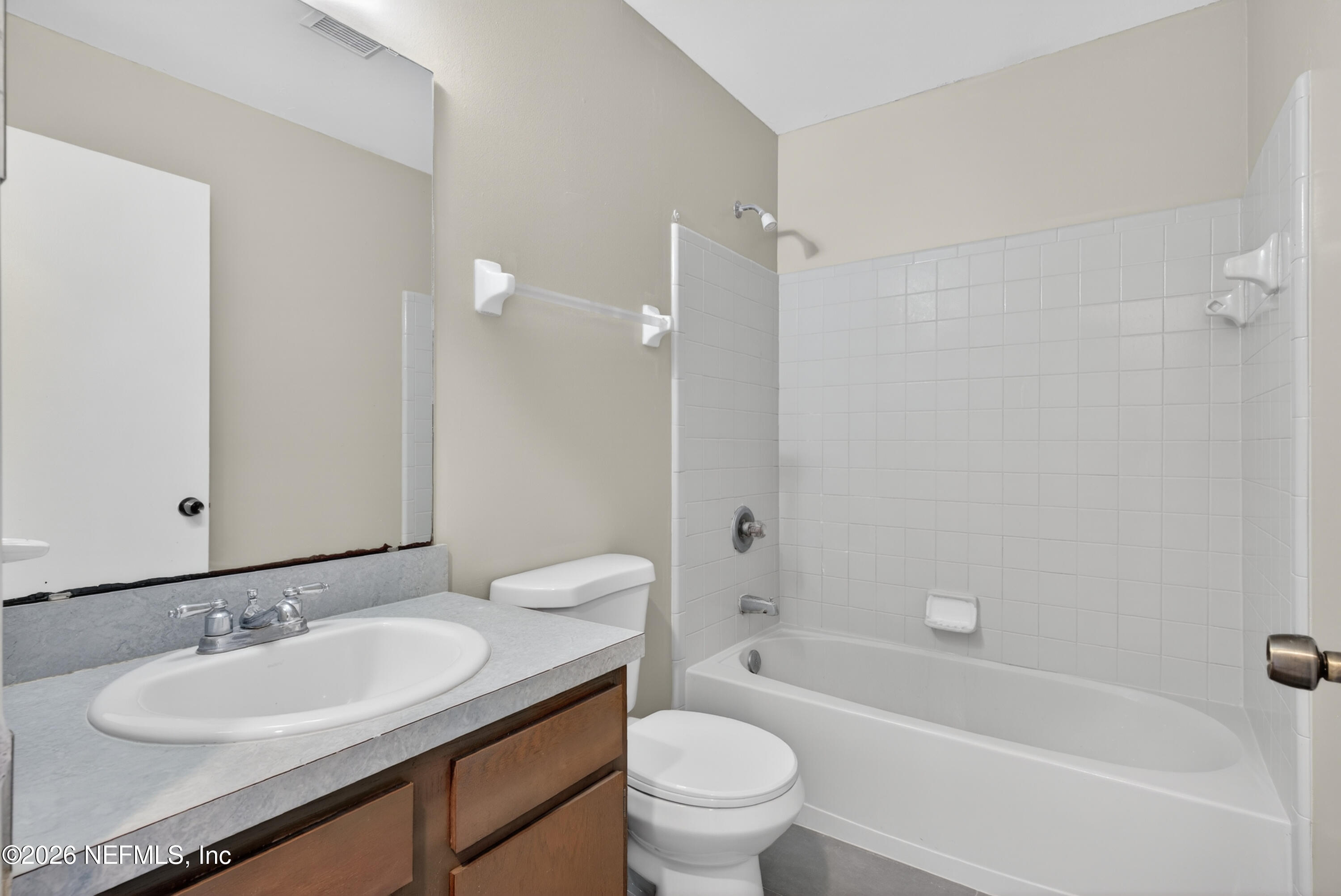 8745 Buzz Court Jacksonville, FL 32216 - Photo 16 of 23 a bathroom with a granite countertop sink toilet mirror and shower