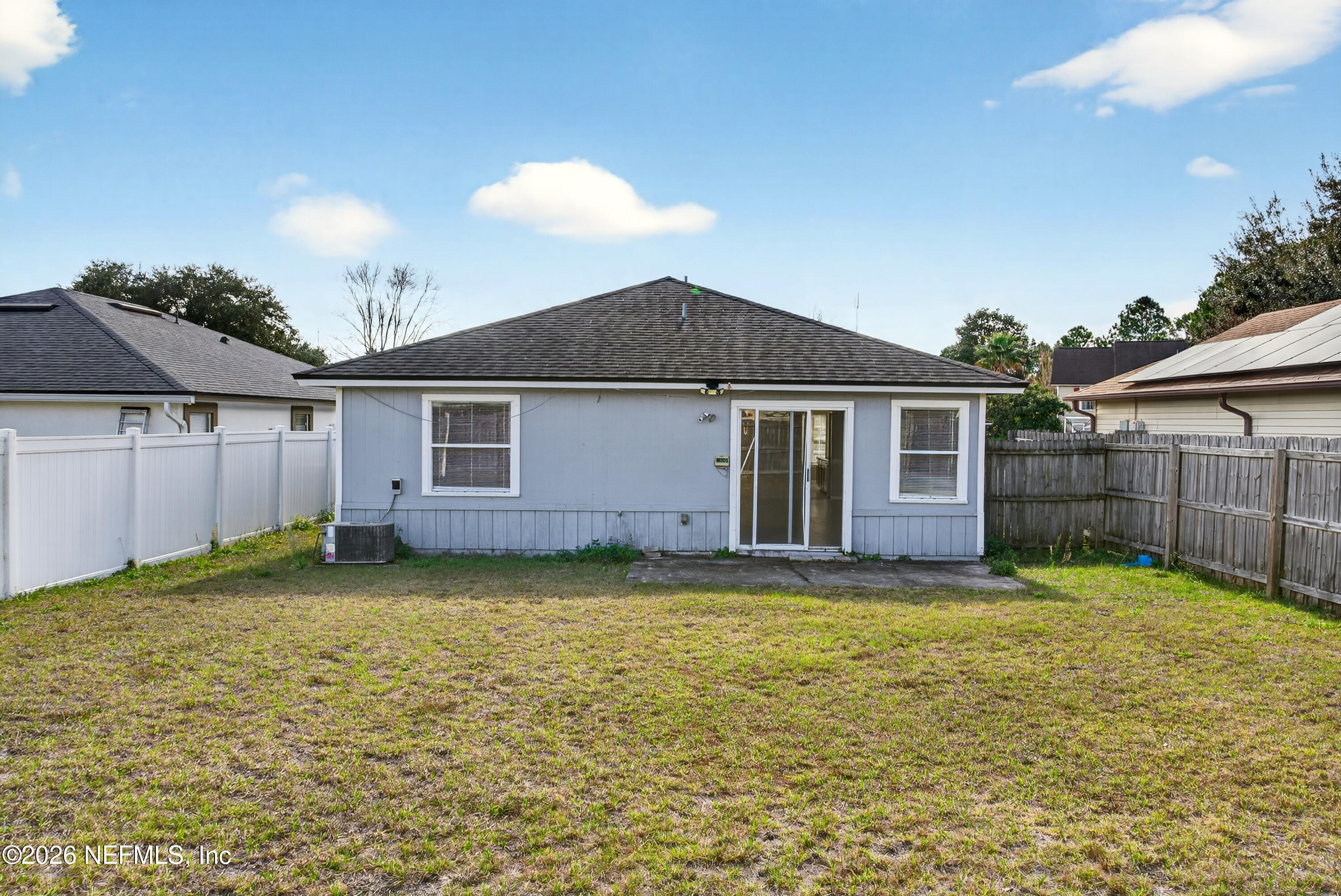 8745 Buzz Court Jacksonville, FL 32216 - Photo 22 of 23 a view of a yard in front of a house with a large tree