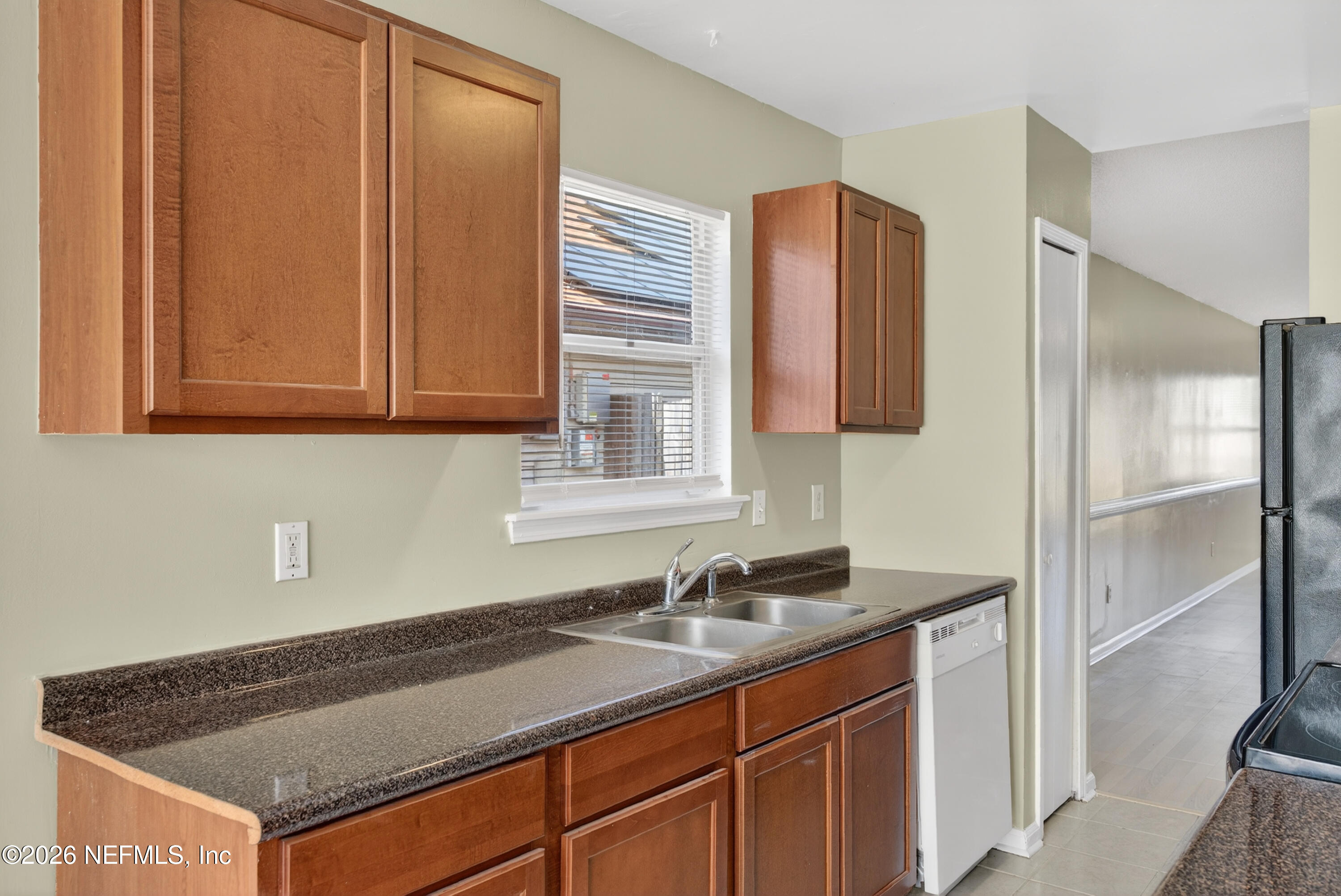 8745 Buzz Court Jacksonville, FL 32216 - Photo 9 of 23 a kitchen with granite countertop a sink cabinets and stainless steel appliances