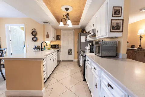 a kitchen with stainless steel appliances a stove a sink and a refrigerator