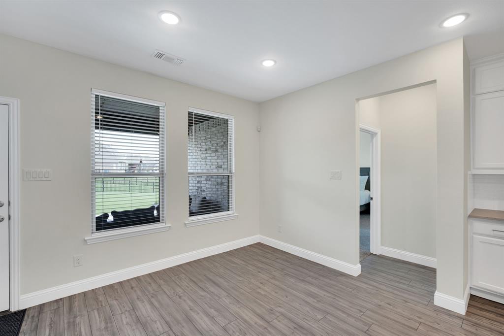 1601 Bear Path Way Gunter, TX 75058 - Photo 13 of 40 an empty room with wooden floor and windows