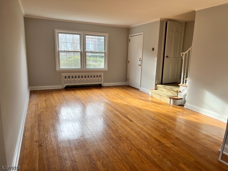 15 Norwood Avenue, Unit B2 Summit, NJ 07901 - Photo 3 of 18 an empty room with wooden floor and windows