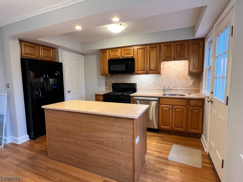 15 Norwood Avenue, Unit B2 Summit, NJ 07901 - Photo 5 of 18 a kitchen with stainless steel appliances a refrigerator stove and microwave