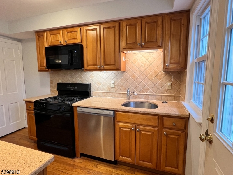 15 Norwood Avenue, Unit B2 Summit, NJ 07901 - Photo 6 of 18 a kitchen with stainless steel appliances granite countertop a sink stove and microwave