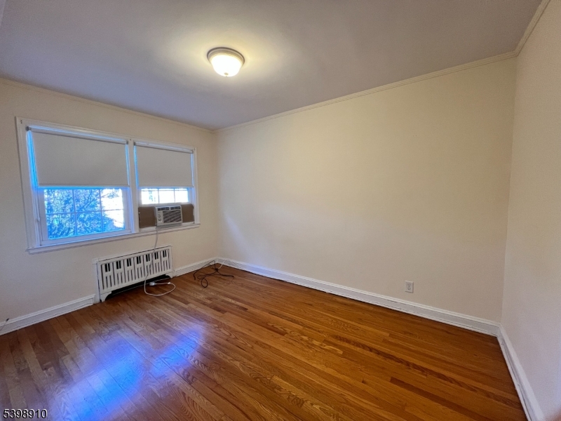 15 Norwood Avenue, Unit B2 Summit, NJ 07901 - Photo 8 of 18 an empty room with wooden floor and windows