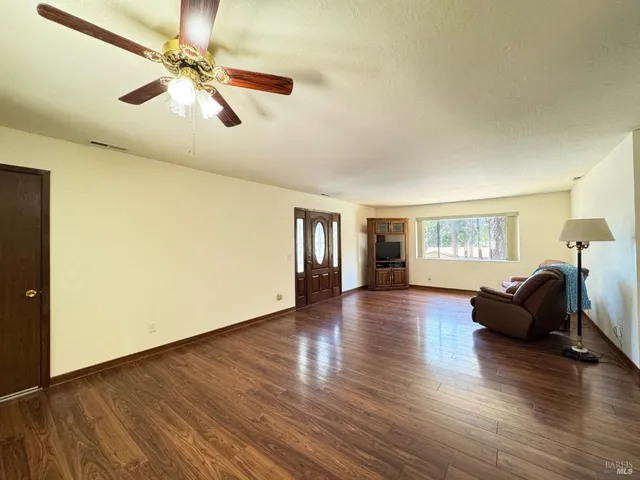 a view of livingroom with hardwood floor and ceiling fan
