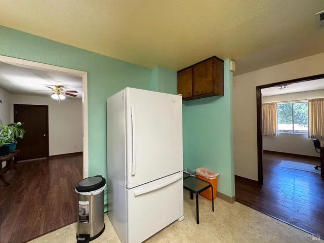 a kitchen with stainless steel appliances a refrigerator and a stove top oven