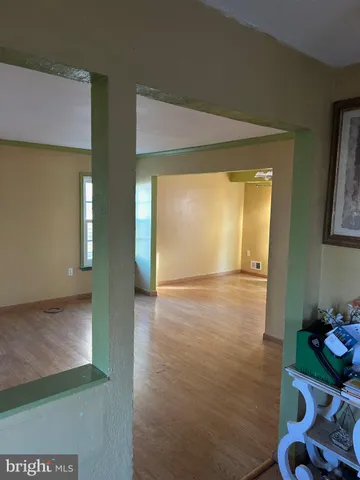 a view of a room with wooden floor