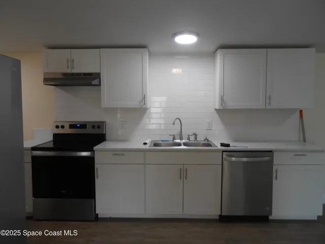 a kitchen with a sink and cabinets