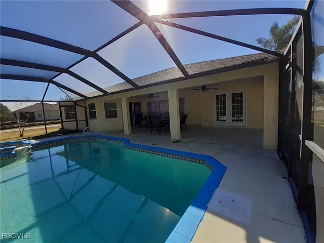 a view of a backyard with a tub and wooden fence