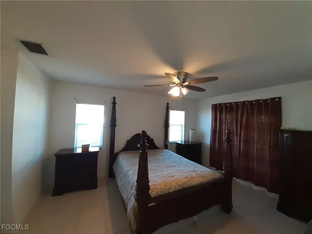 a bedroom with a bed and window