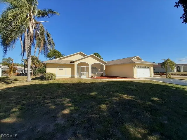 a front view of a house with a garden