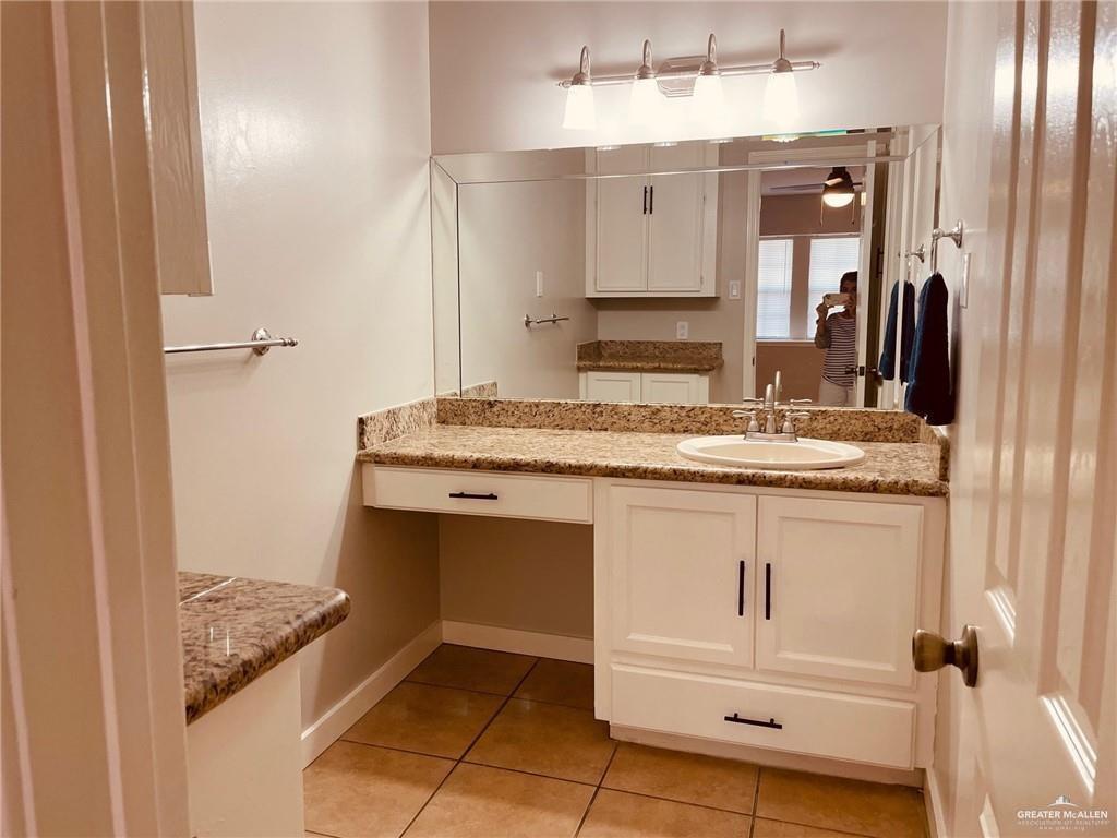 1206 Bluebird Avenue McAllen, TX 78504 - Photo 15 of 20 a bathroom with a granite countertop sink and a mirror