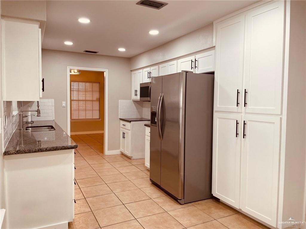 1206 Bluebird Avenue McAllen, TX 78504 - Photo 6 of 20 a kitchen with stainless steel appliances granite countertop a refrigerator and a sink