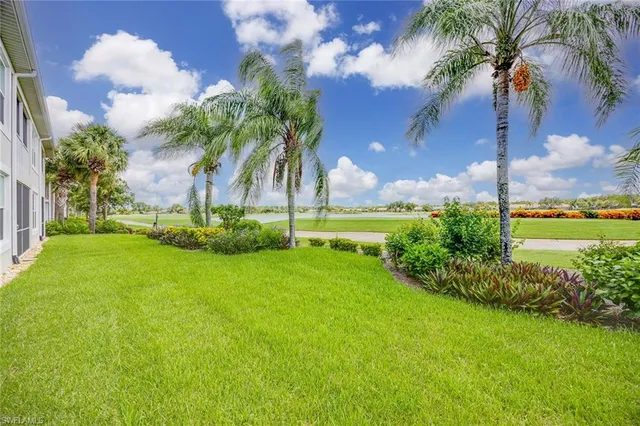 a view of a lake with houses in the background