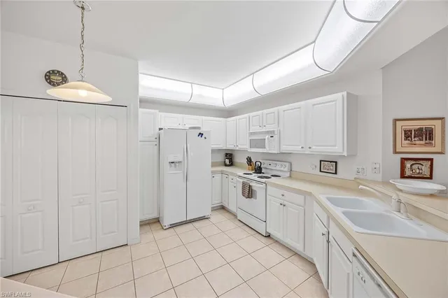 a view of a dining room and livingroom with furniture wooden floor and a chandelier