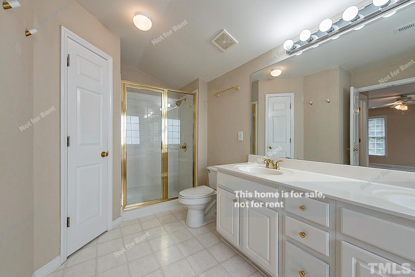 2340 Bolingbrook Lane Raleigh, NC 27613 - Photo 16 of 24 a bathroom with a granite countertop sink a toilet a mirror and shower
