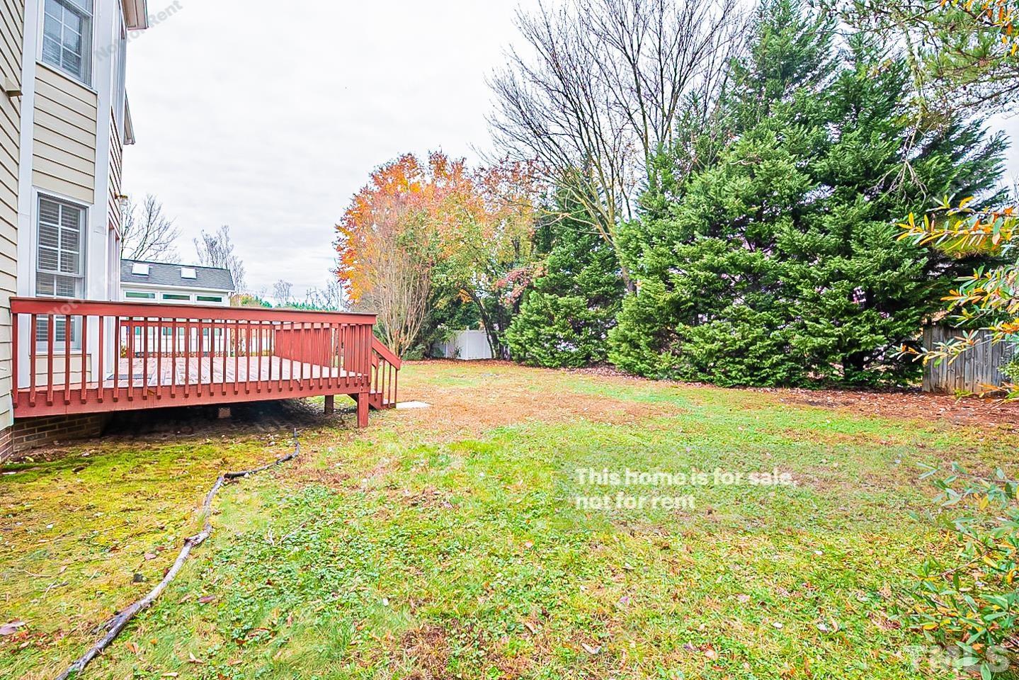 2340 Bolingbrook Lane Raleigh, NC 27613 - Photo 23 of 24 a view of a yard with large tree and wooden fence