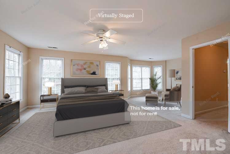 2340 Bolingbrook Lane Raleigh, NC 27613 - Photo 3 of 24 a bedroom with a large bed and a chandelier