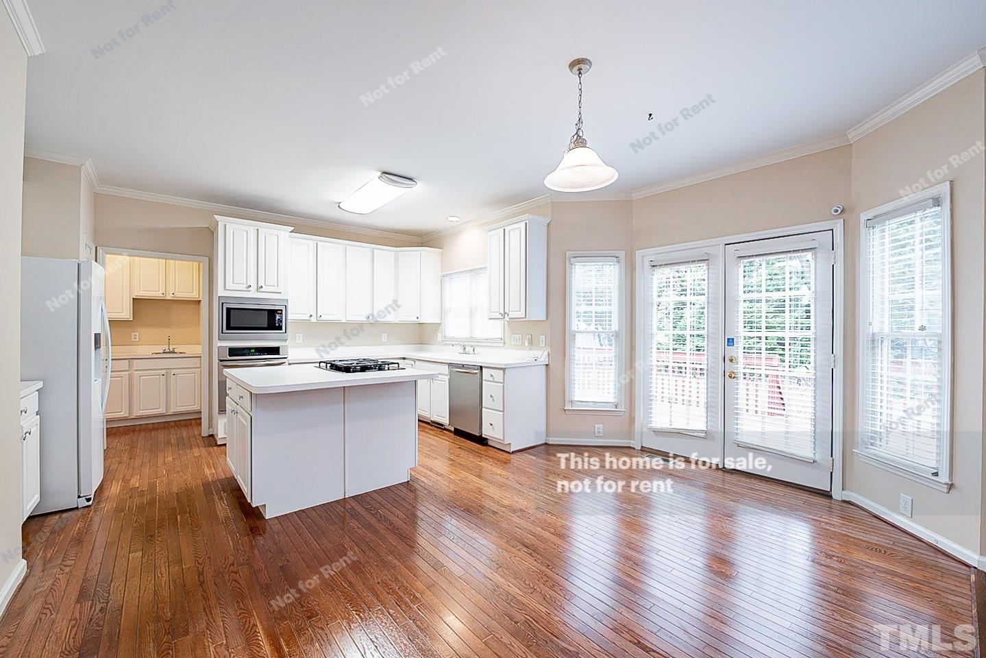 2340 Bolingbrook Lane Raleigh, NC 27613 - Photo 4 of 24 a large kitchen with cabinets wooden floor and stainless steel appliances