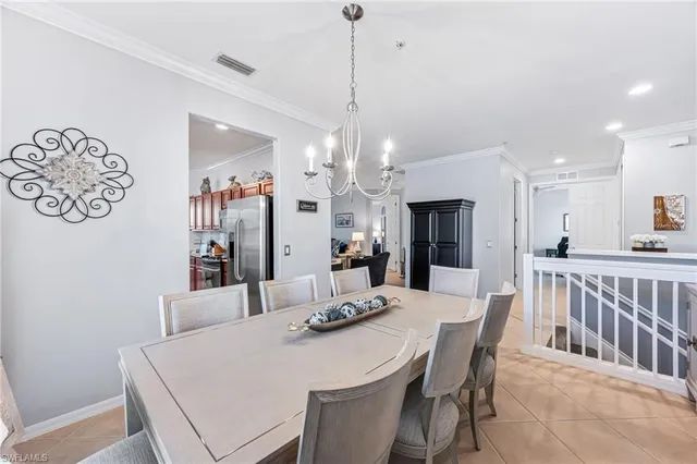 a view of a dining room with furniture and a chandelier