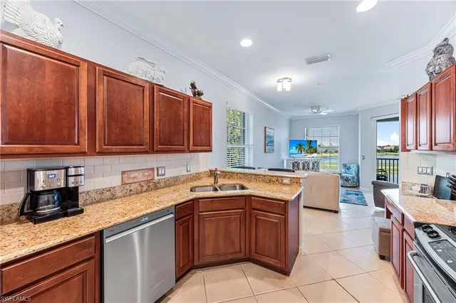 a kitchen with a sink counter top space and stainless steel appliances