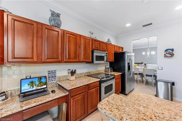 a kitchen with stainless steel appliances granite countertop a stove top oven a sink dishwasher a dining table and chairs with wooden floor