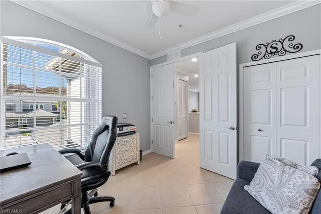 a view of a workspace with furniture and a window