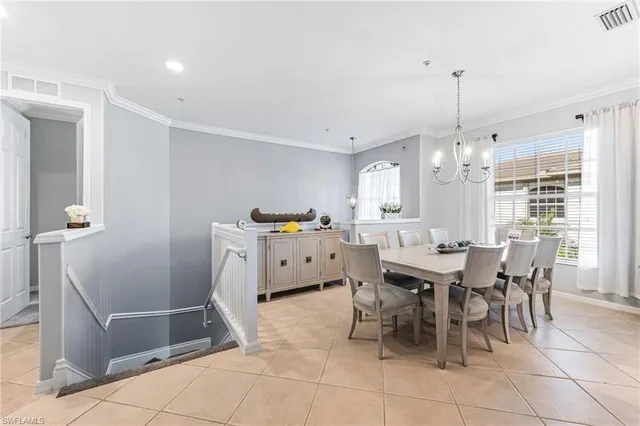a view of a dining room with furniture and a chandelier