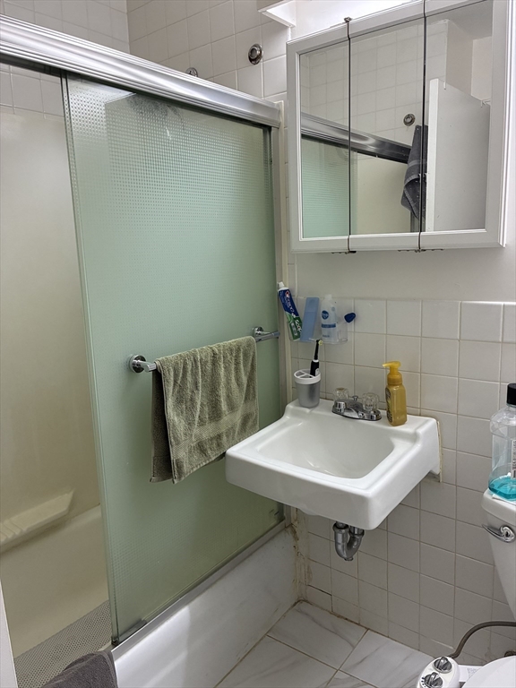 142 Kenrick Street, Unit 34 Boston, MA 02135 - Photo 8 of 8 a bathroom with a sink and mirror