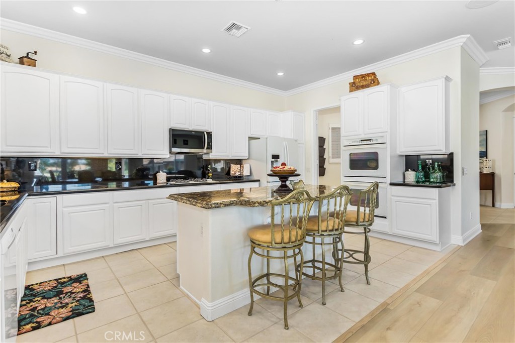 5233 Hampton Road Banning, CA 92220 - Photo 7 of 46 a kitchen with stainless steel appliances granite countertop a stove a sink a microwave and a refrigerator
