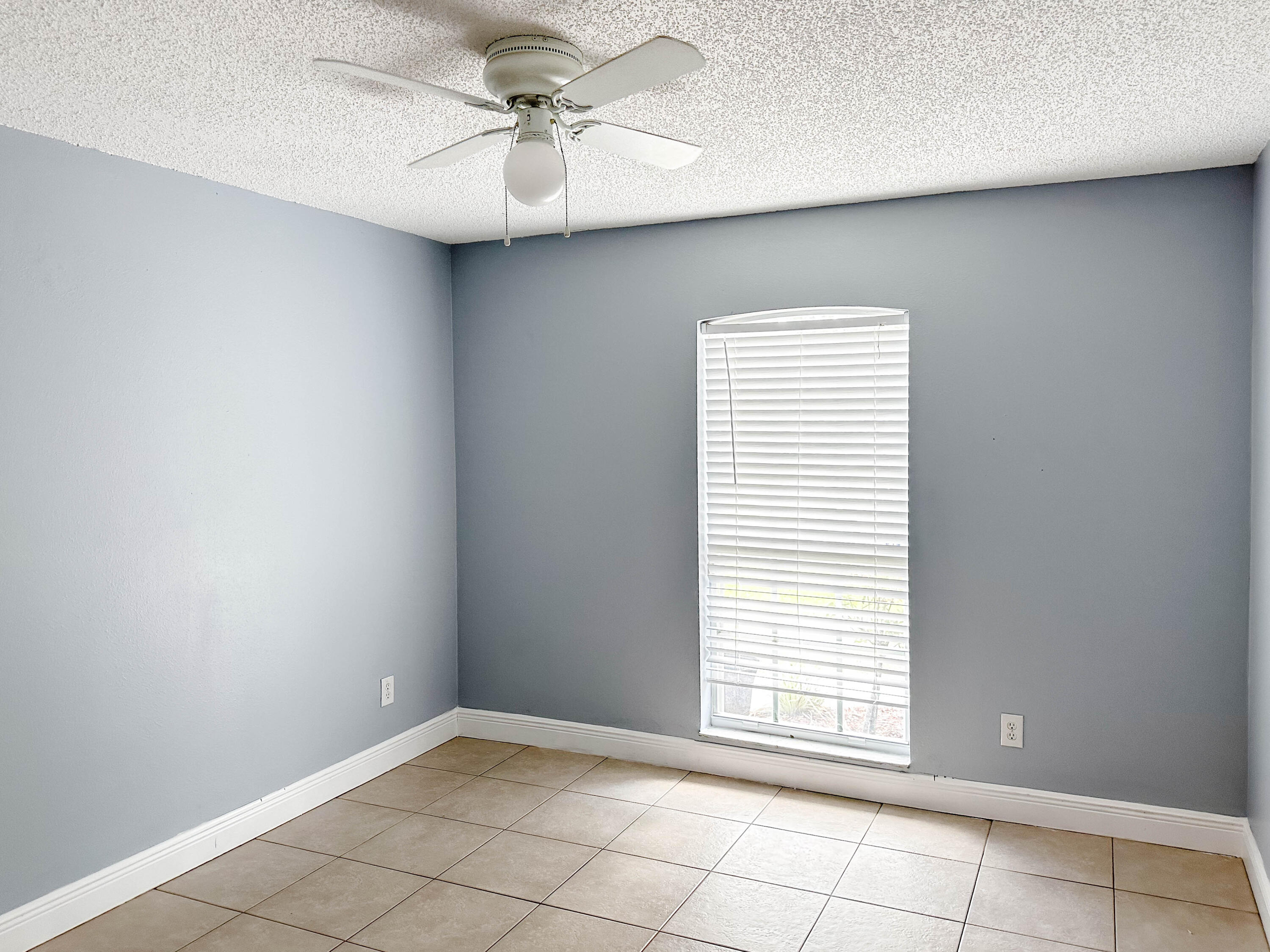 816 Tedder Road Southeast Palm Bay, FL 32909 - Photo 11 of 15 an empty room with windows and fan