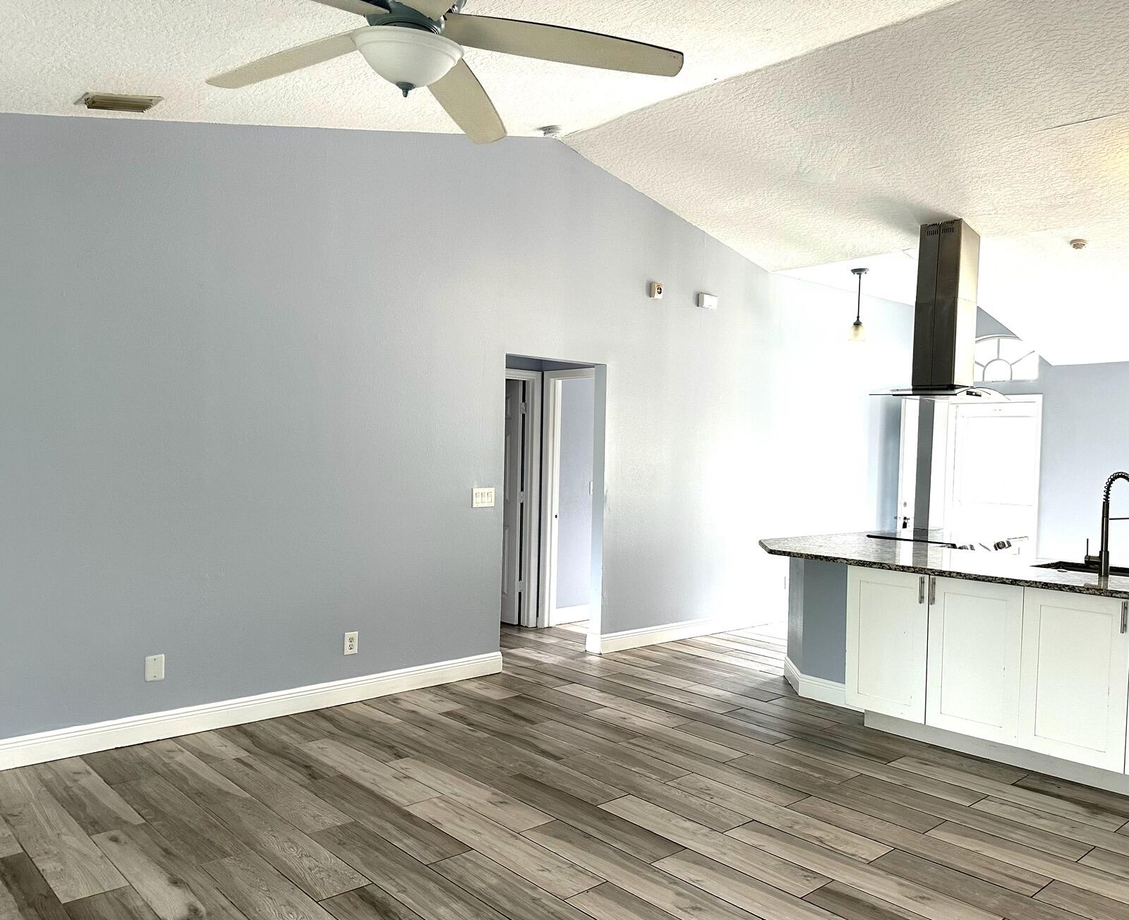 816 Tedder Road Southeast Palm Bay, FL 32909 - Photo 5 of 15 a view of a kitchen with a sink and wooden floor
