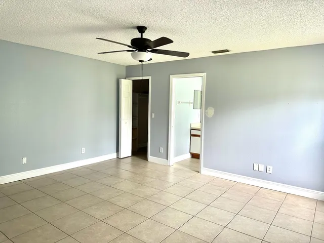 a view of a livingroom with a ceiling fan and wooden floor