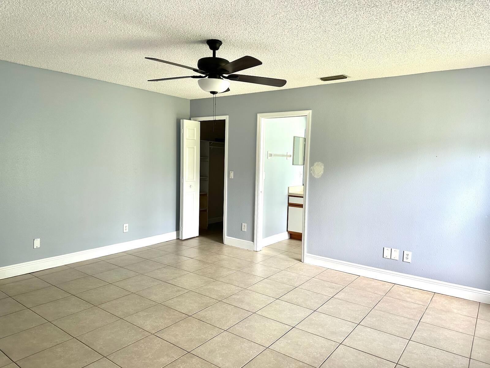 816 Tedder Road Southeast Palm Bay, FL 32909 - Photo 6 of 15 a view of a livingroom with a ceiling fan and wooden floor