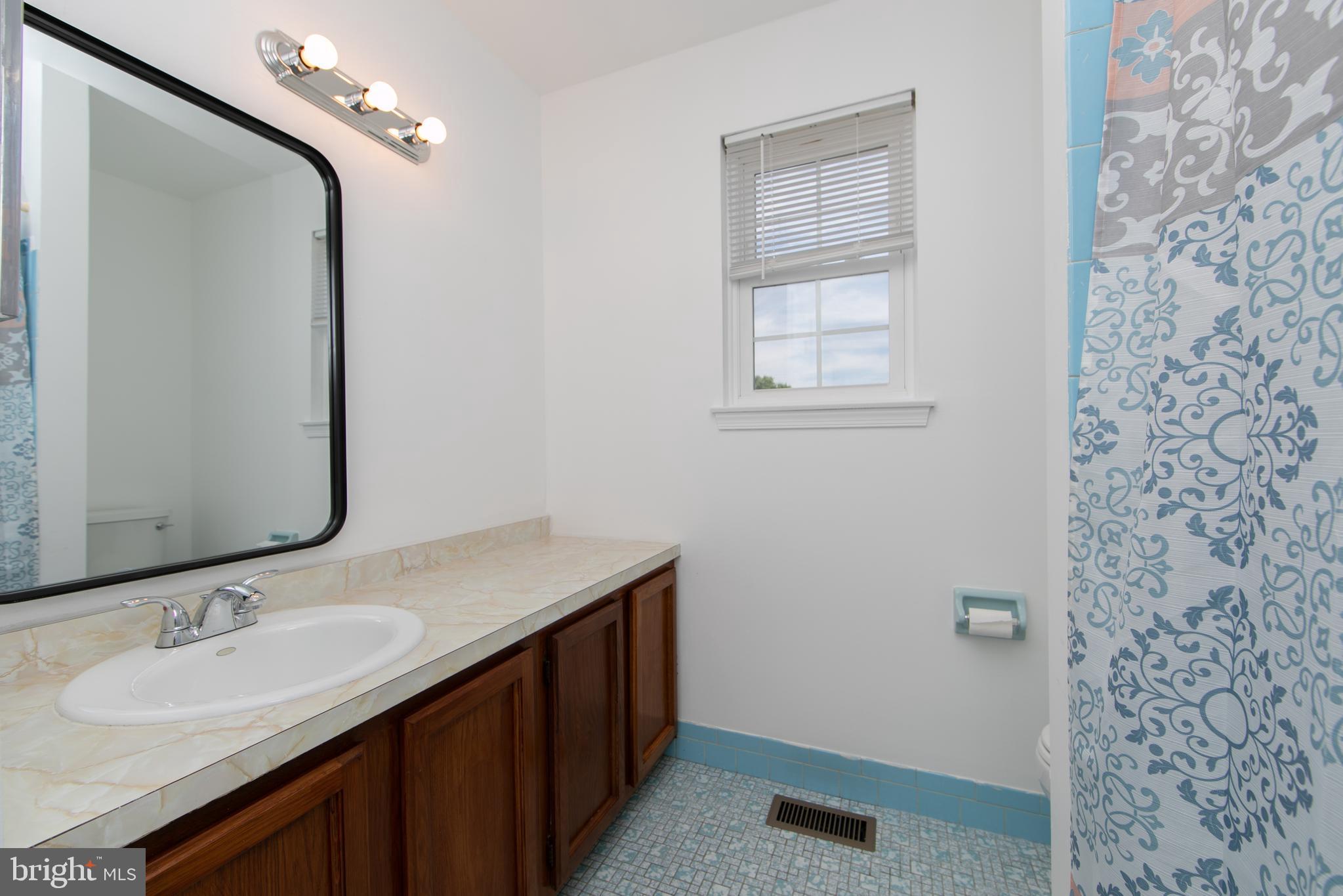 3007 Rampart Road Bensalem, PA 19020 - Photo 36 of 48 a bathroom with a sink a vanity and a mirror