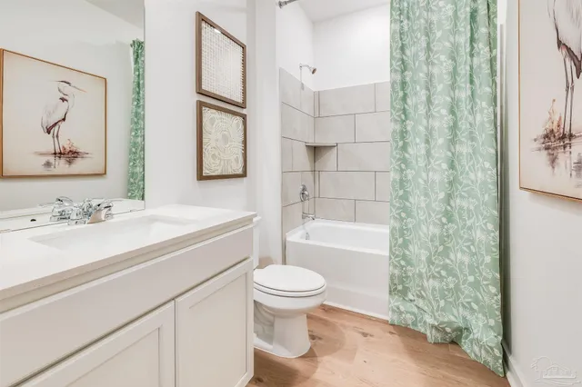 a bathroom with a sink a toilet and a large mirror