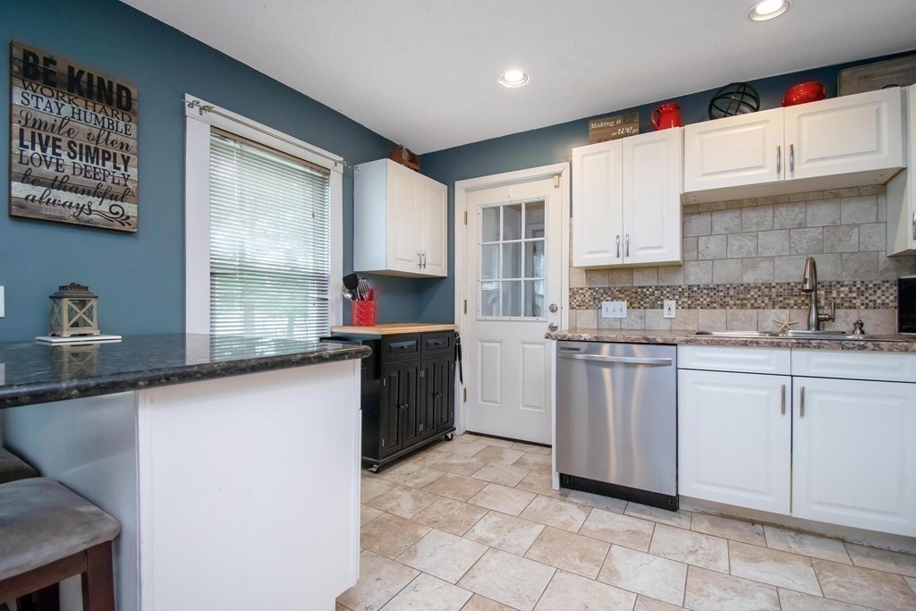 220 Nottingham Street Springfield, MA 01104 - Photo 11 of 30 a kitchen with granite countertop a sink stove and cabinets