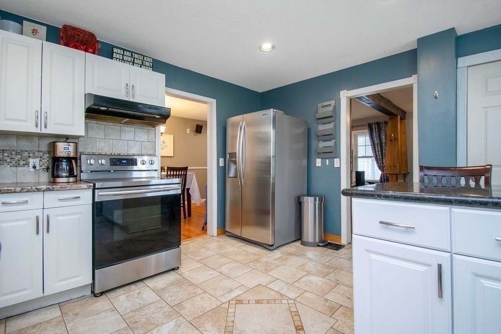 220 Nottingham Street Springfield, MA 01104 - Photo 13 of 30 a kitchen with stainless steel appliances granite countertop a stove a refrigerator and a sink