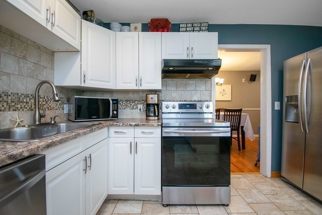 220 Nottingham Street Springfield, MA 01104 - Photo 14 of 30 a kitchen with stainless steel appliances granite countertop a sink stove and refrigerator
