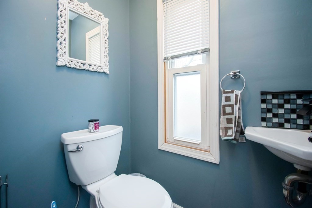 220 Nottingham Street Springfield, MA 01104 - Photo 16 of 30 a white toilet sitting next to a bathroom sink