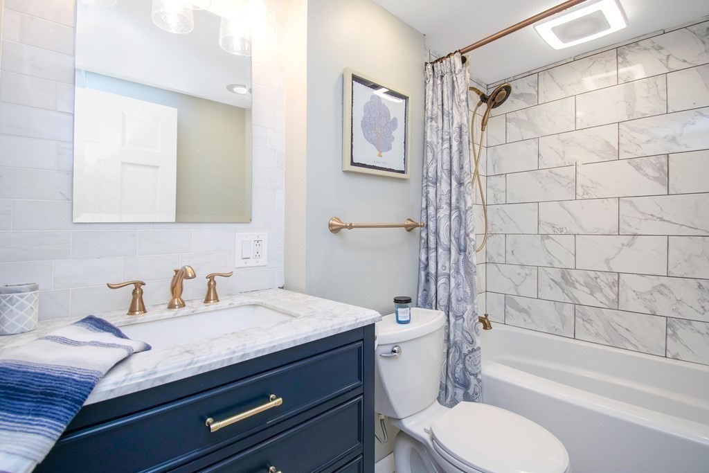220 Nottingham Street Springfield, MA 01104 - Photo 20 of 30 a bathroom with a granite countertop toilet sink and bathtub