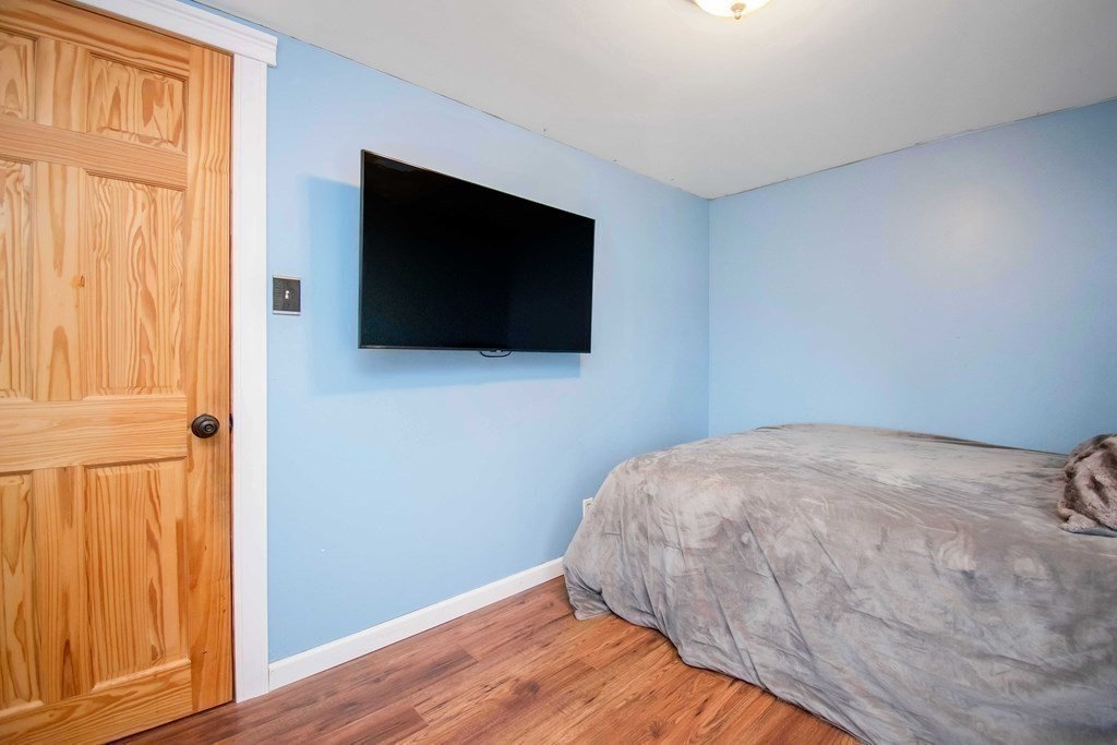 220 Nottingham Street Springfield, MA 01104 - Photo 22 of 30 a view of a livingroom with wooden floor and a flat screen tv